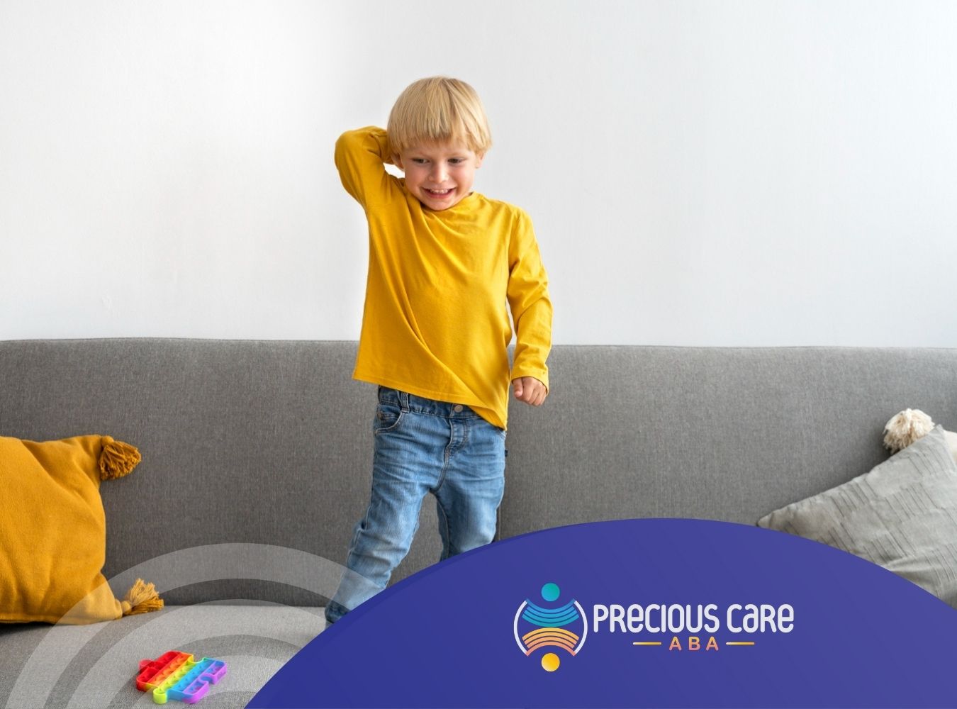 Autistic child standing on a sofa.