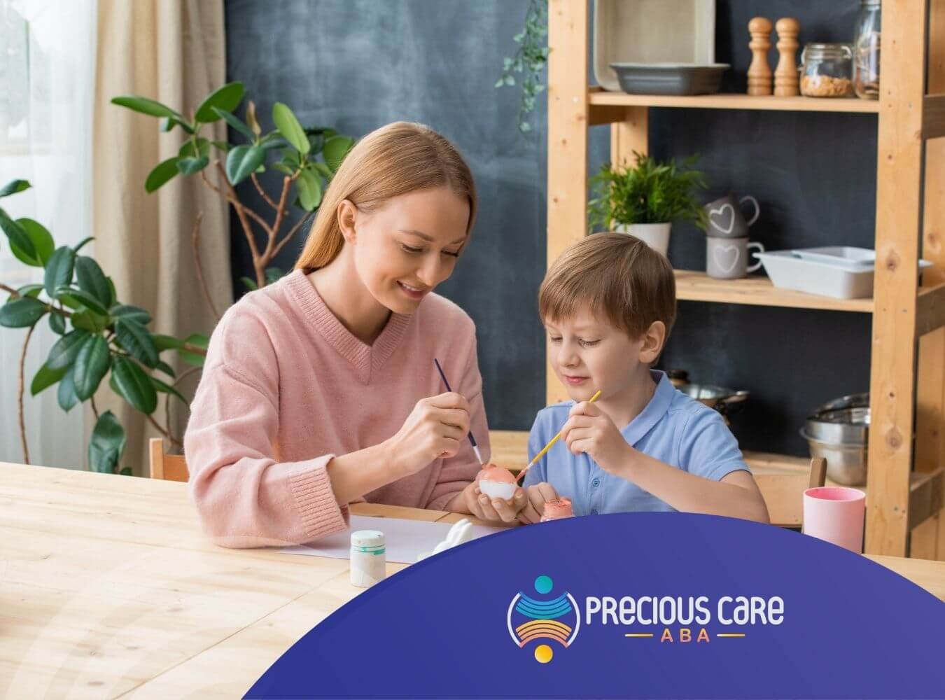 An ABA therapist and autistic child are painting Easter eggs together at the table in ABA therapy.