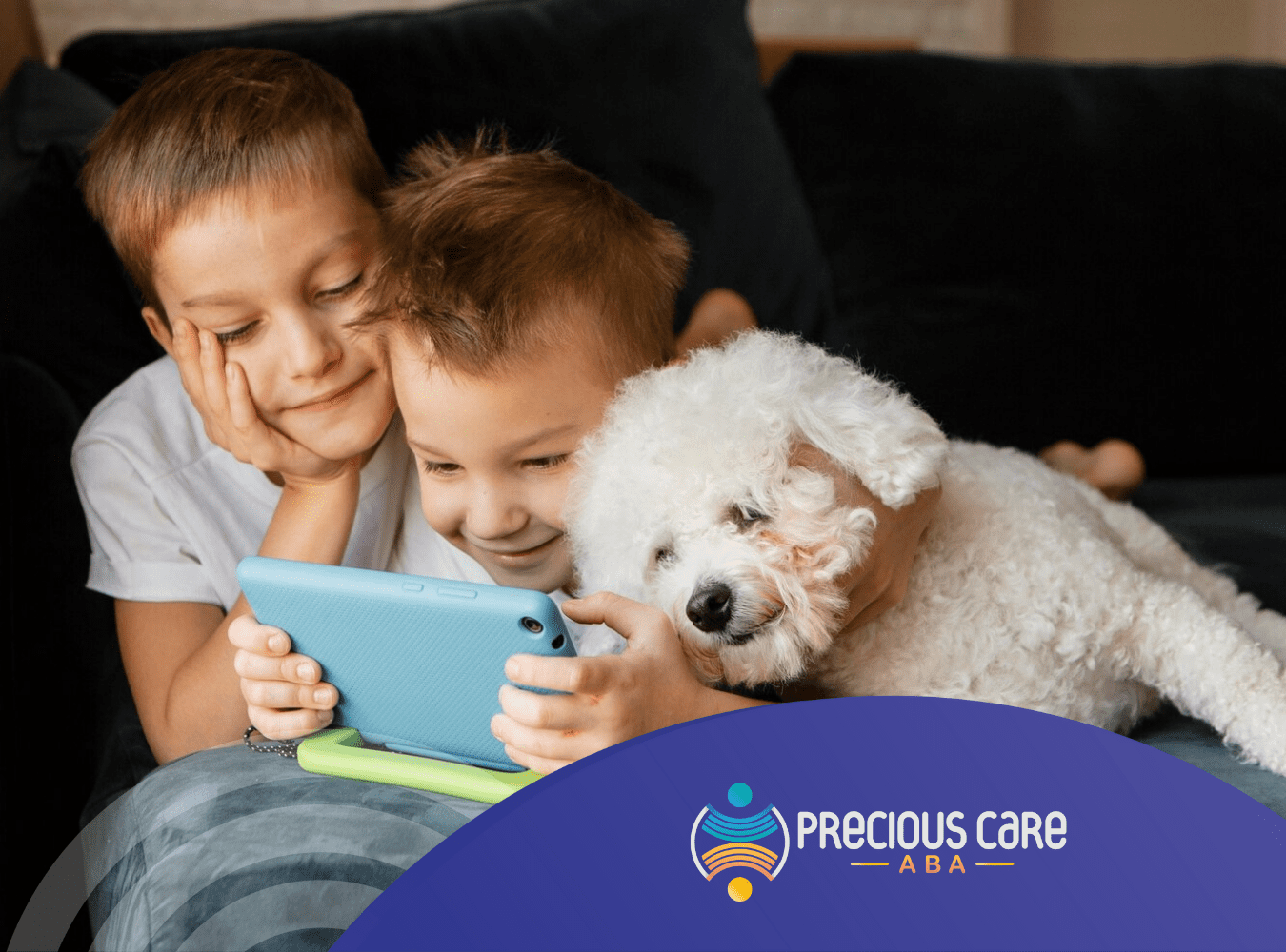 Two children with autism playing on a phone with their pet dog