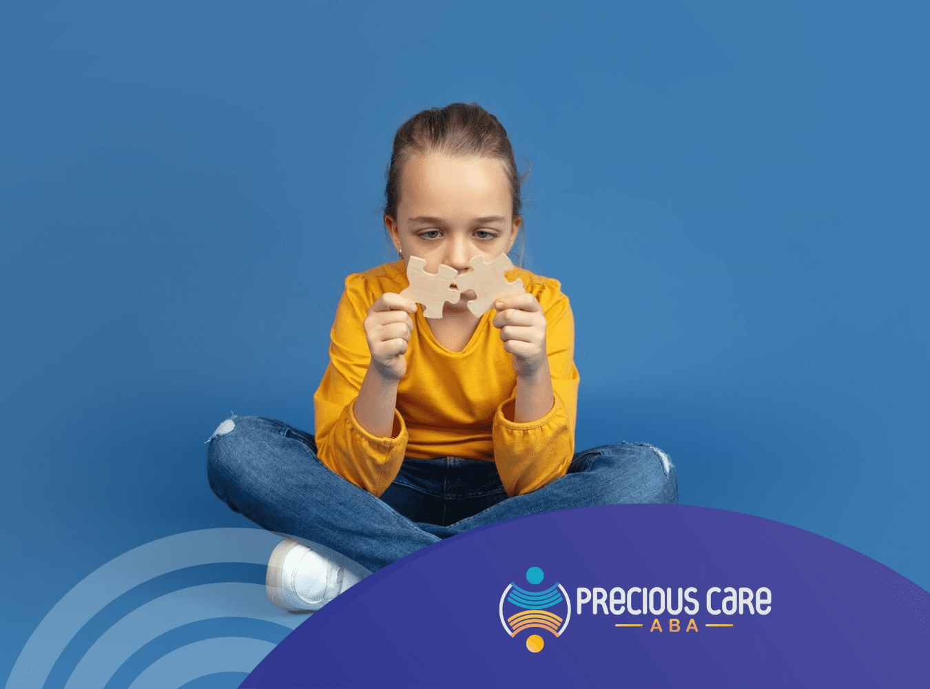 A girl with severe autism holding two puzzle pieces