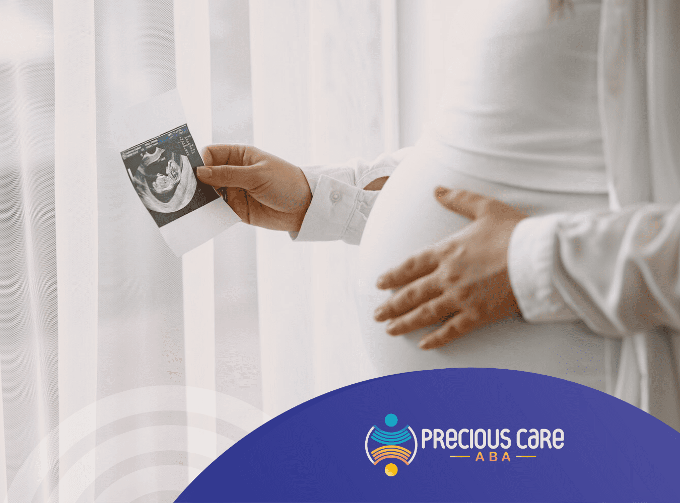 A pregnant woman looking at an ultrasound print