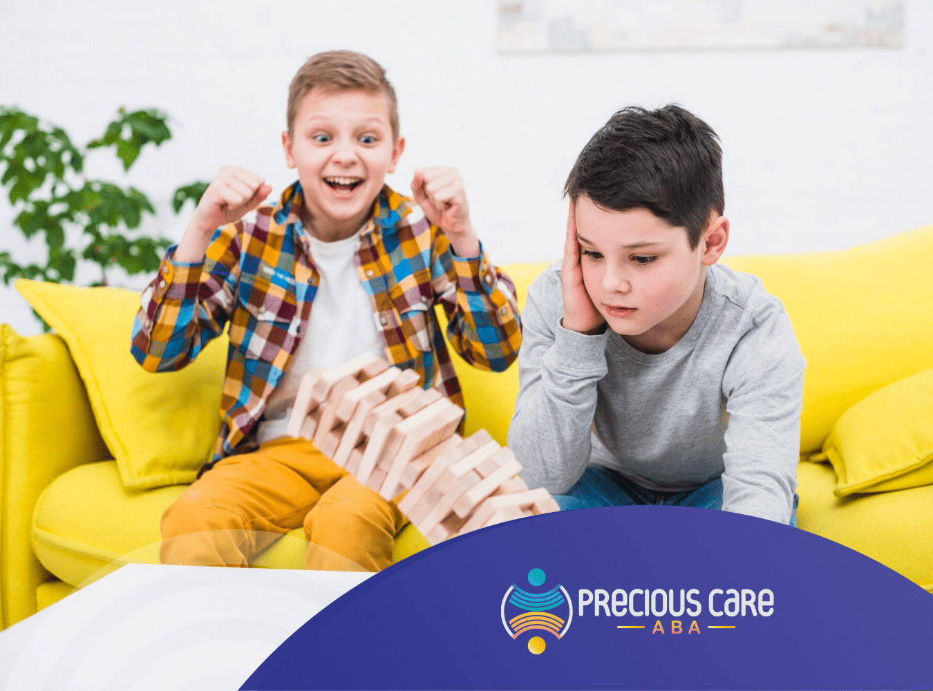 Two kids happily playing Jenga