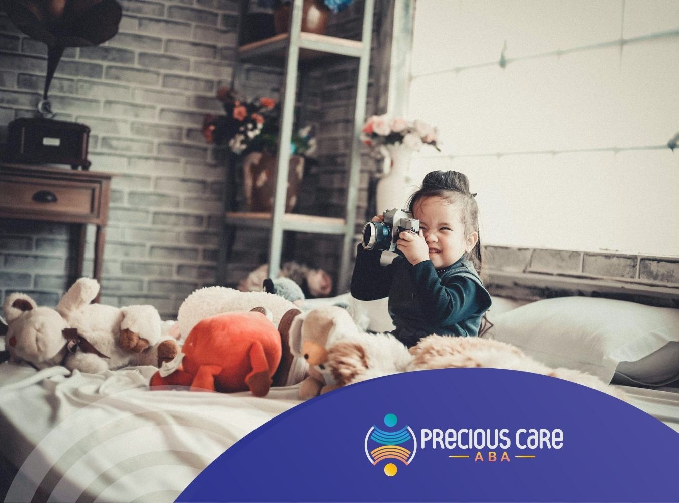 An autistic girl sits on a bed with stuffed animals, holding a vintage camera and smiling in MD.