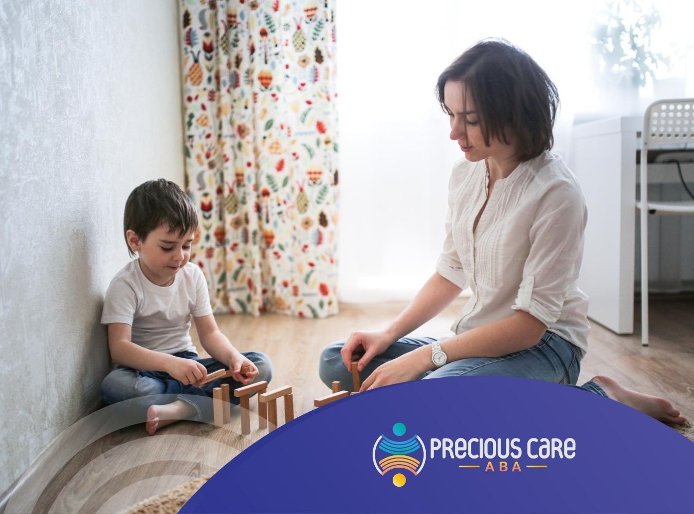ABA therapist and autistic boy sitting on the floor playing with wooden domino blocks.