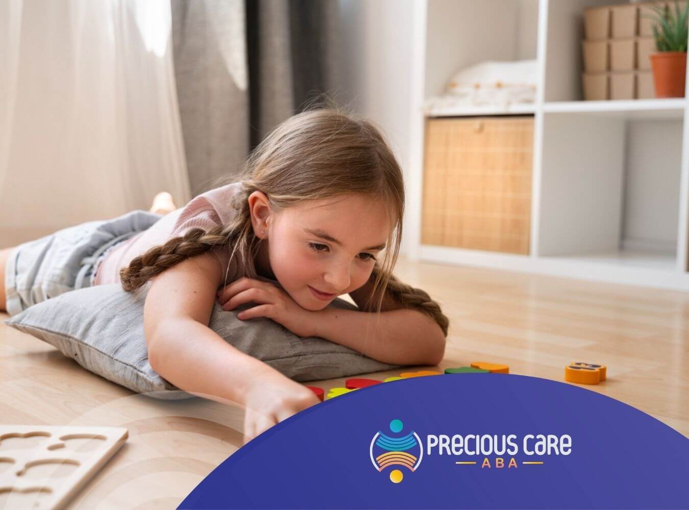A young girl is playing with colorful number blocks on the floor in ABA therapy.