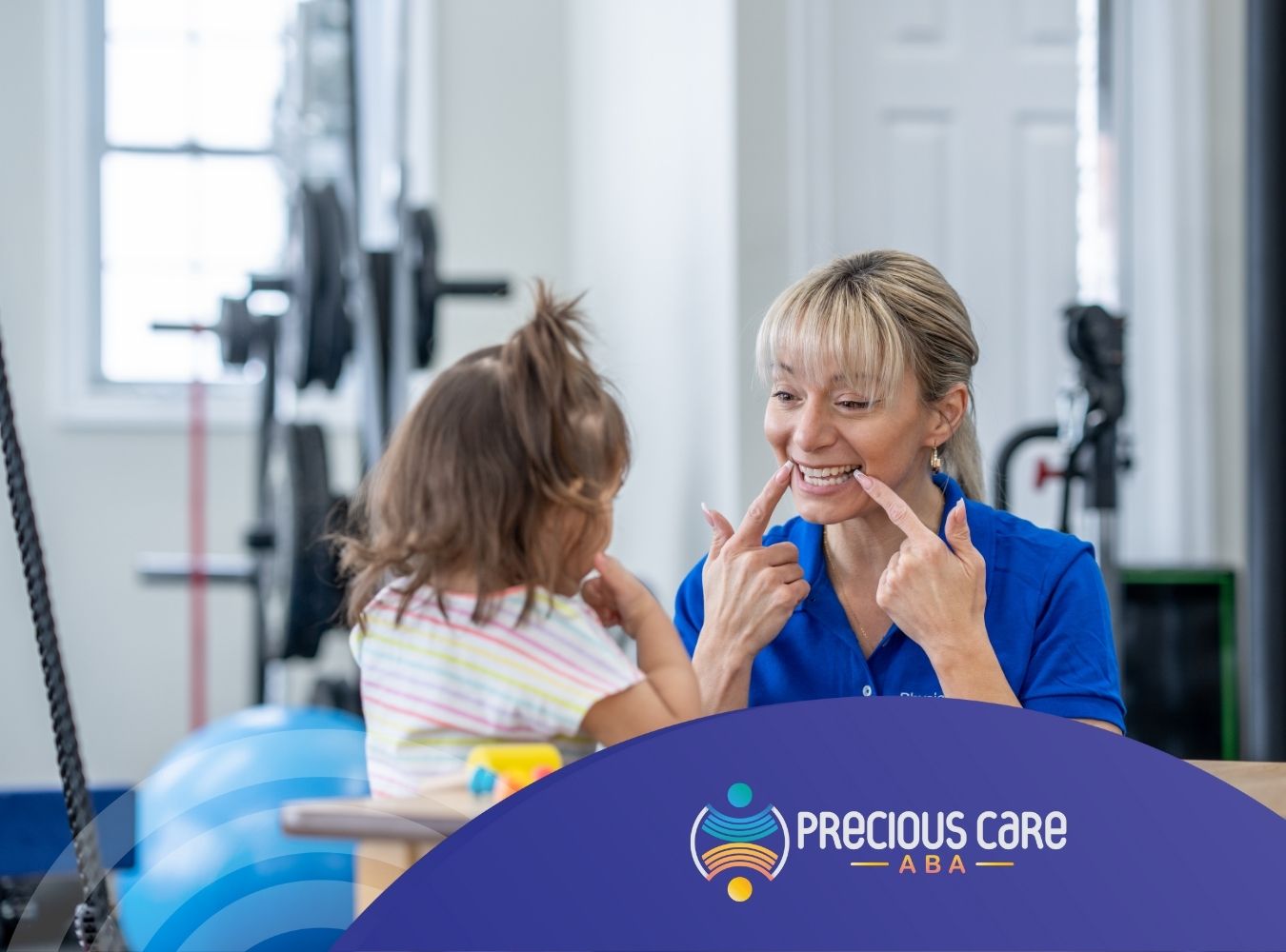 An ABA therapist teaching a little girl how to smile.
