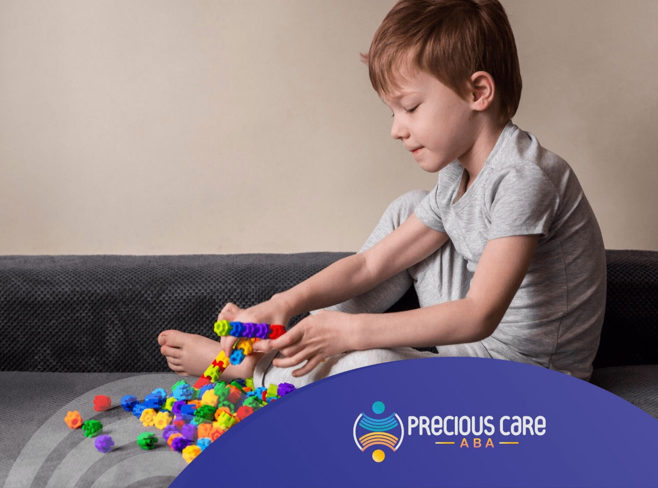 A child playing with colorful toys on a couch