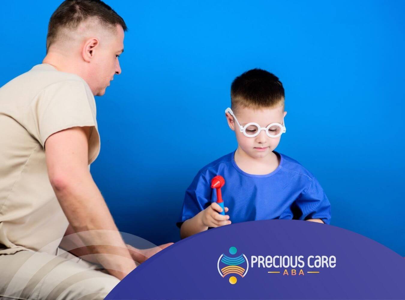 Boy wearing toy doctor glasses and using a reflex hammer, supervised by a pediatrician during autism evaluation.