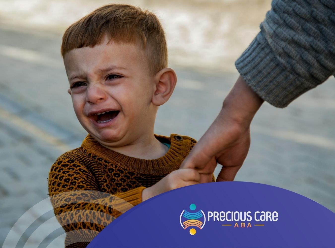 Crying autistic toddler with regressive autism holding an RBT's hand on a paved street in CO.