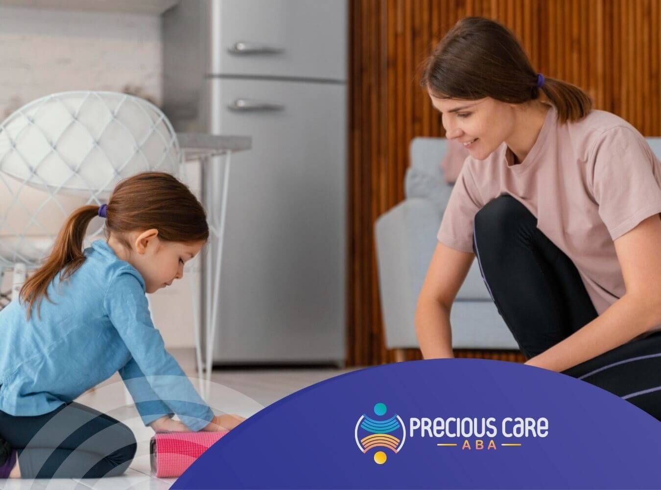 ABA therapist and autistic girl rolling up a pink yoga mat on the floor in during ABA therapy.