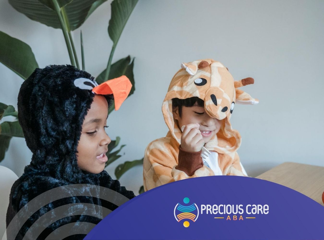 Autistic children wearing penguin and giraffe costumes, playing with toys during ABA therapy in NJ.