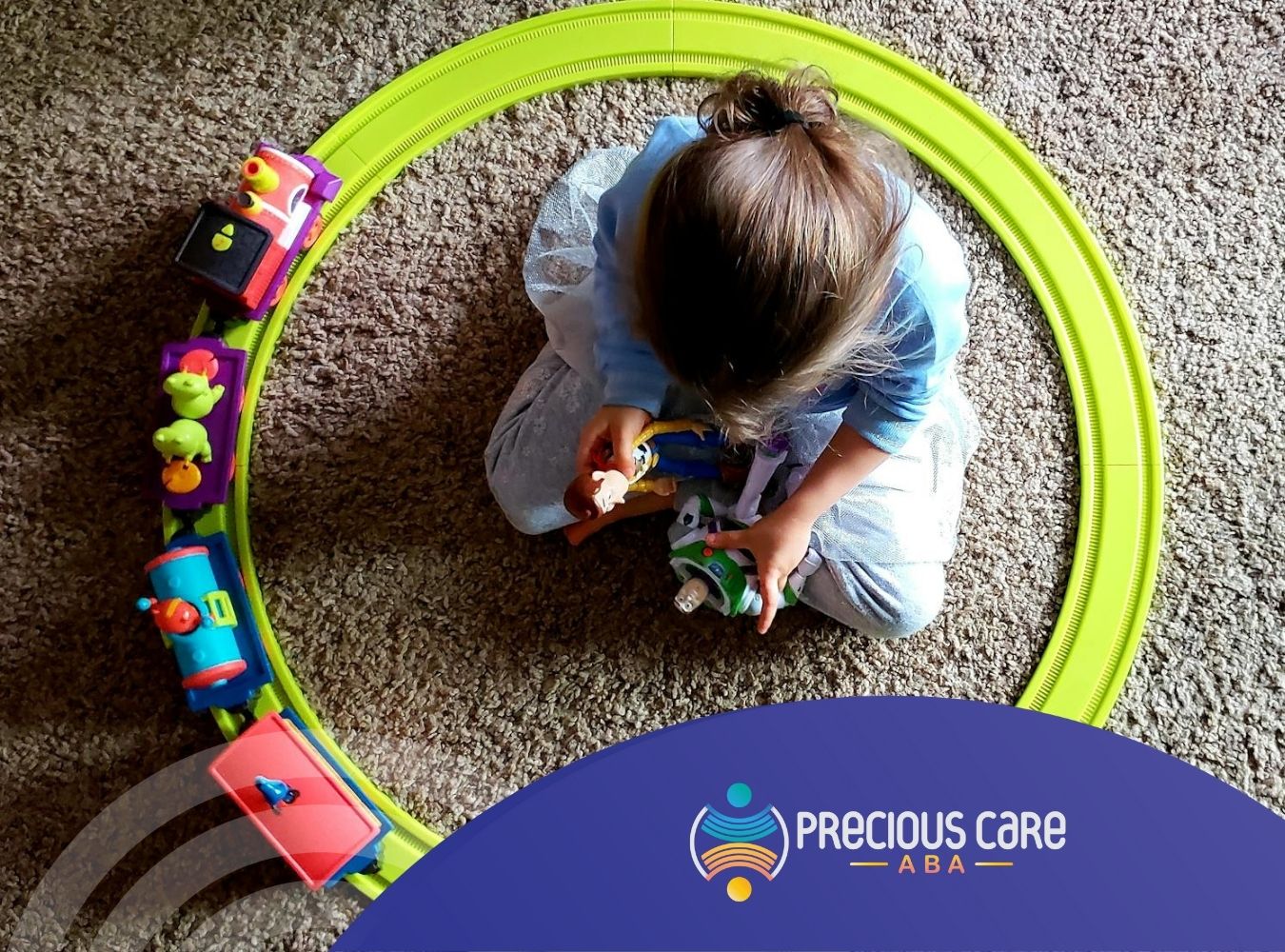 A young autistic child playing with toy trains and figurines on the floor during ABA therapy in MD.
