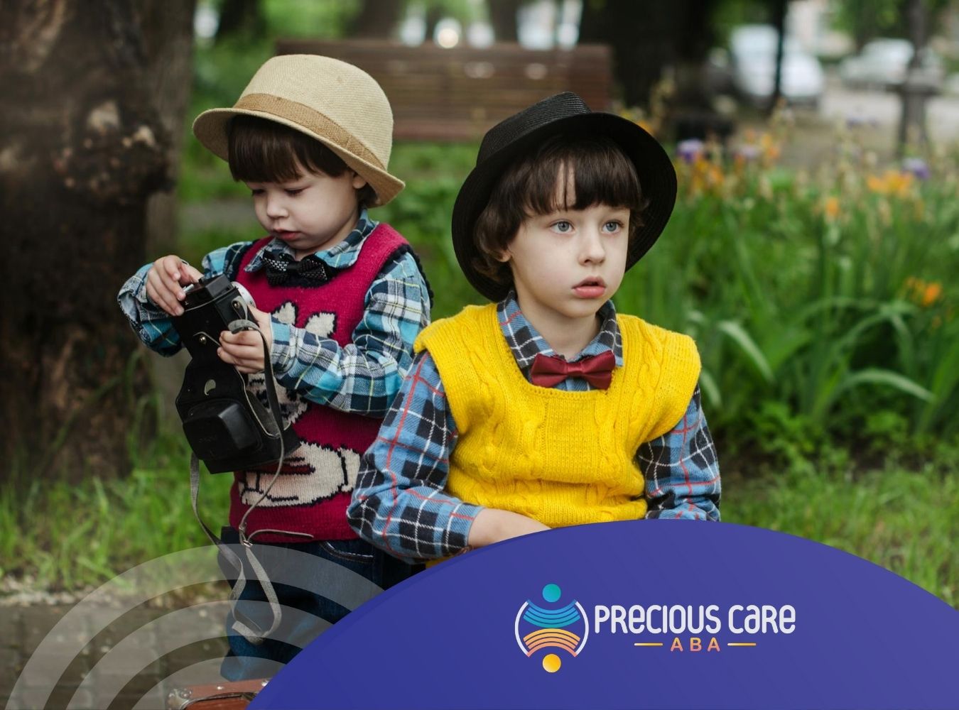 Two autistic boys in hats and vests holding vintage cameras during ABA therapy session outdoors in New Jersey.