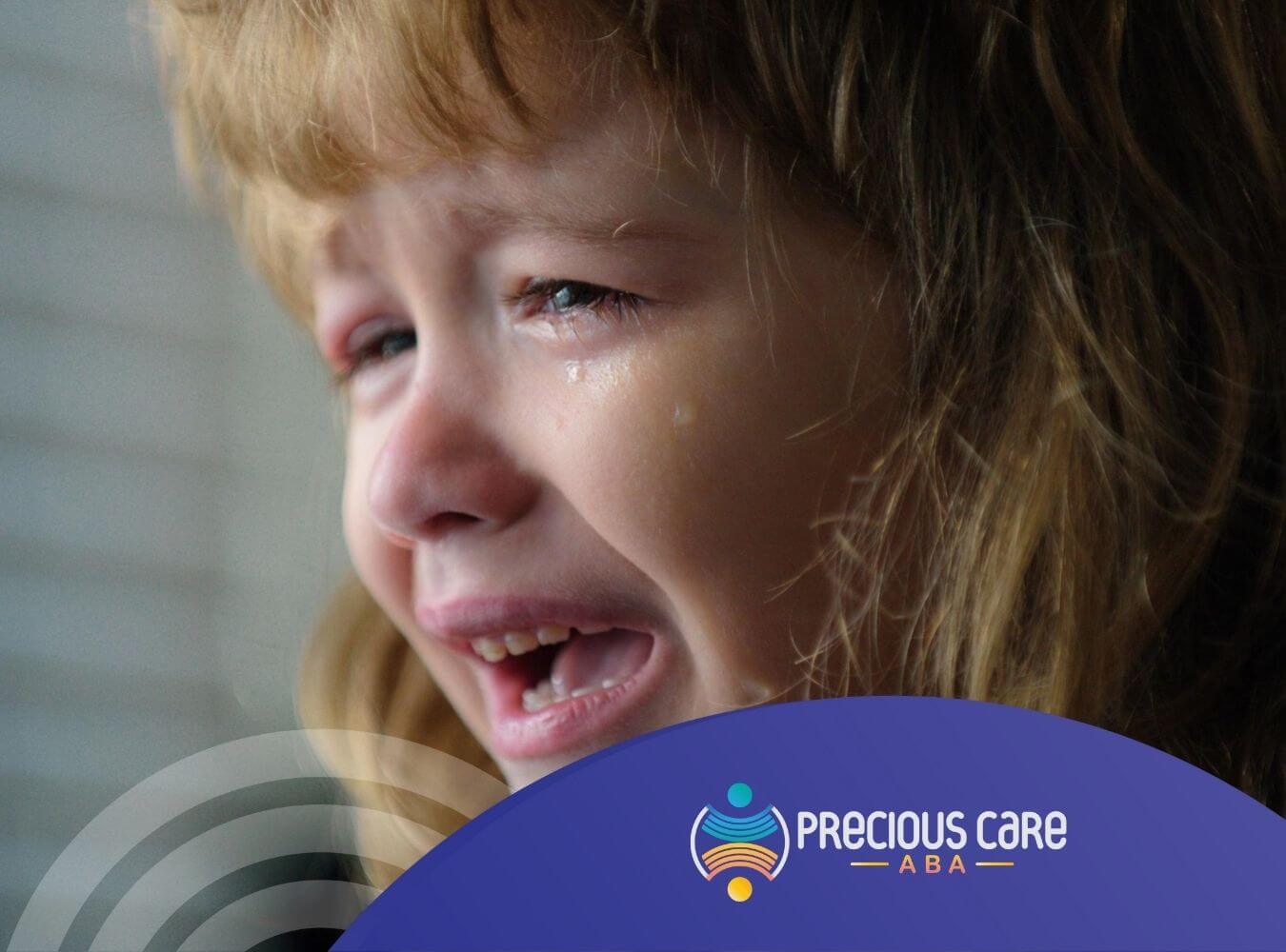 Close-up of a crying young girl with tears on her cheeks in ABA therapy