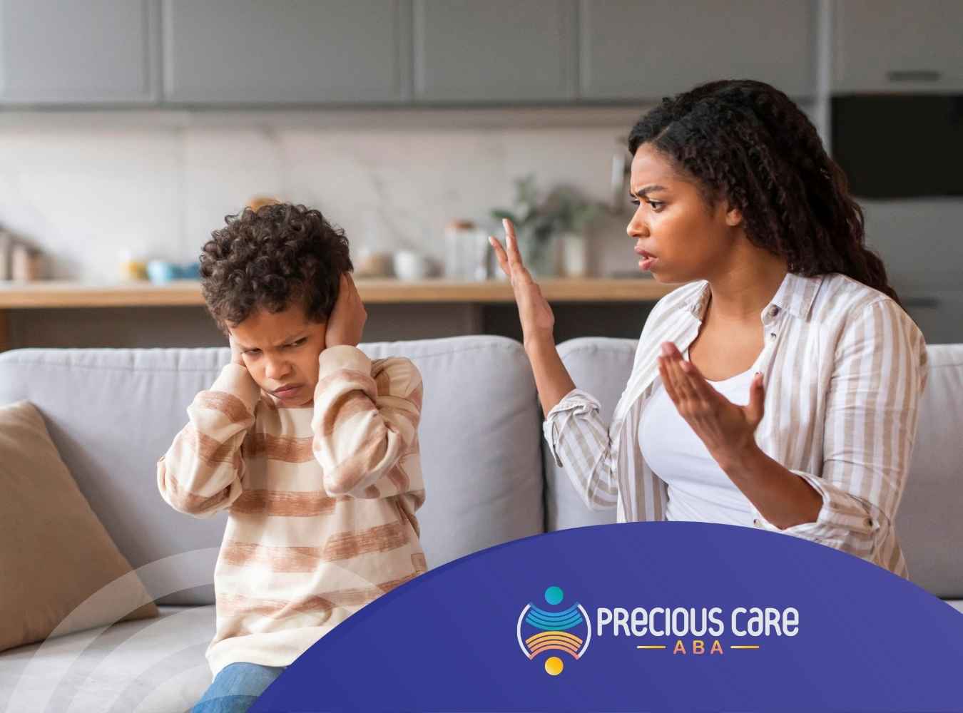 A woman gestures emotionally while a child sits on a sofa, covering their ears and looking upset. The setting is a cozy living room, conveying tension.