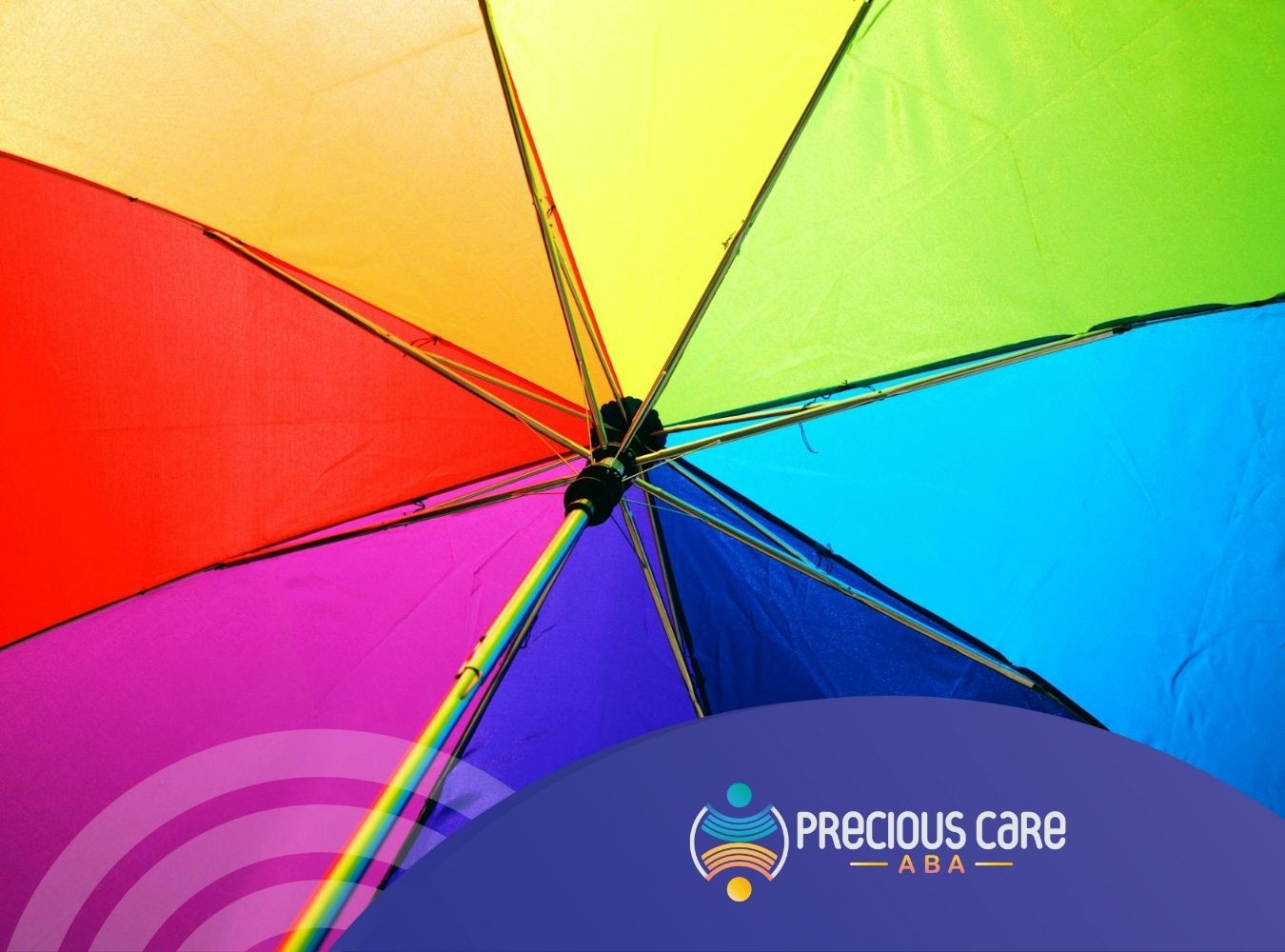 Close-up of a rainbow-colored umbrella outdoors in New Jersey, symbolizing the autism spectrum wheel.