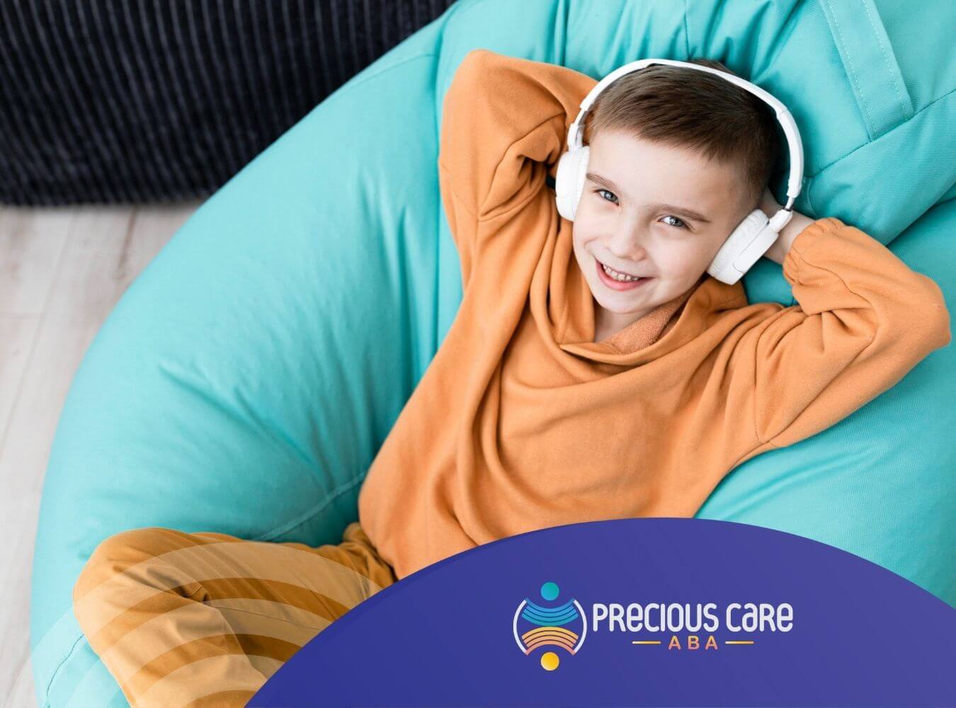 A boy with autism relaxing on beanbag chair wearing headphones.