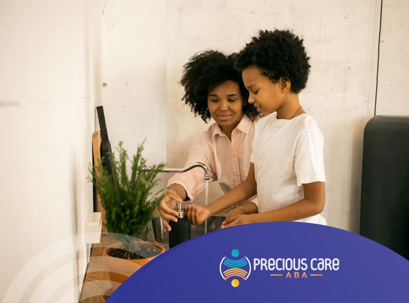 A behavioral technician helping an autistic child wash hands at kitchen sink during in-home ABA therapy in MD.