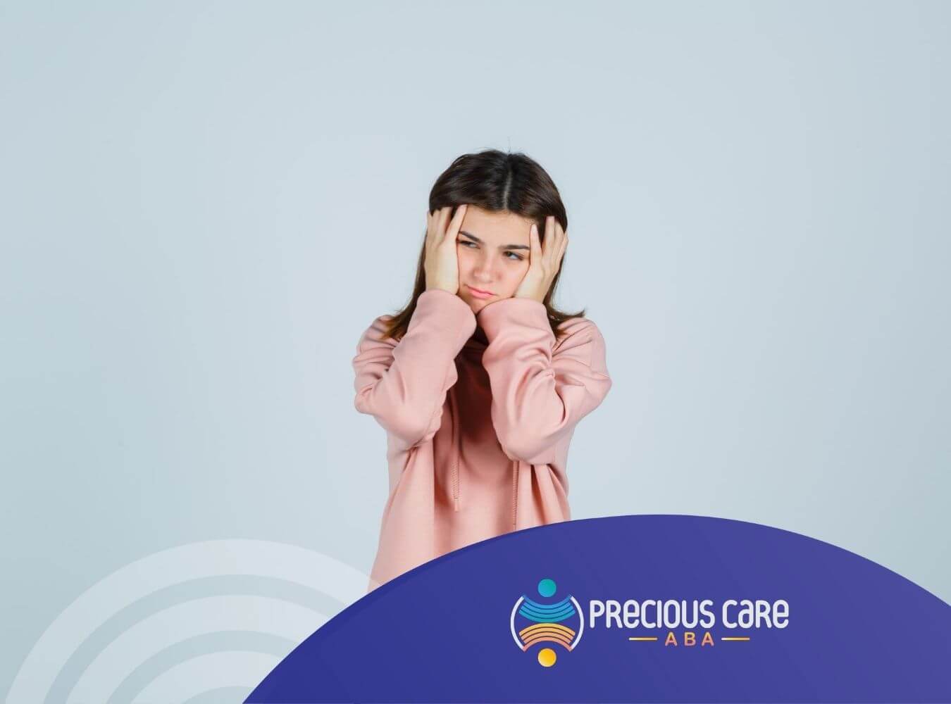A teen girl with autism holding her head with a worried expression.