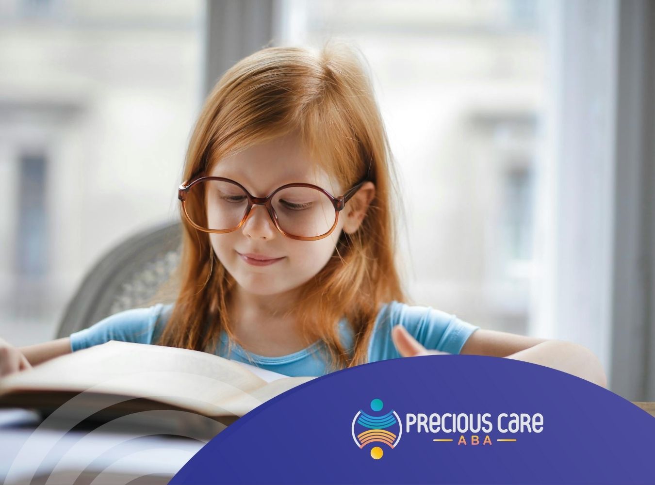 An autistic girl with big glasses reading a book at desk during in-home ABA therapy session in Colorado.