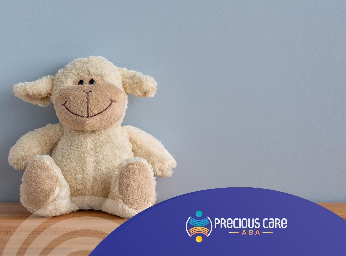 Stuffed sheep toy smiling on wooden table, one of the toys that can relax or calm autistic individuals down.