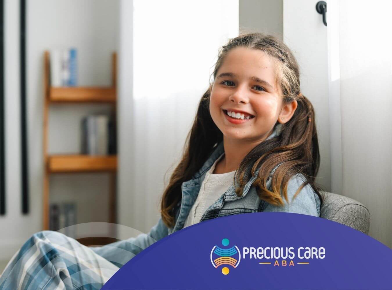 Smiling girl with autism sitting on a chair in a bright room.