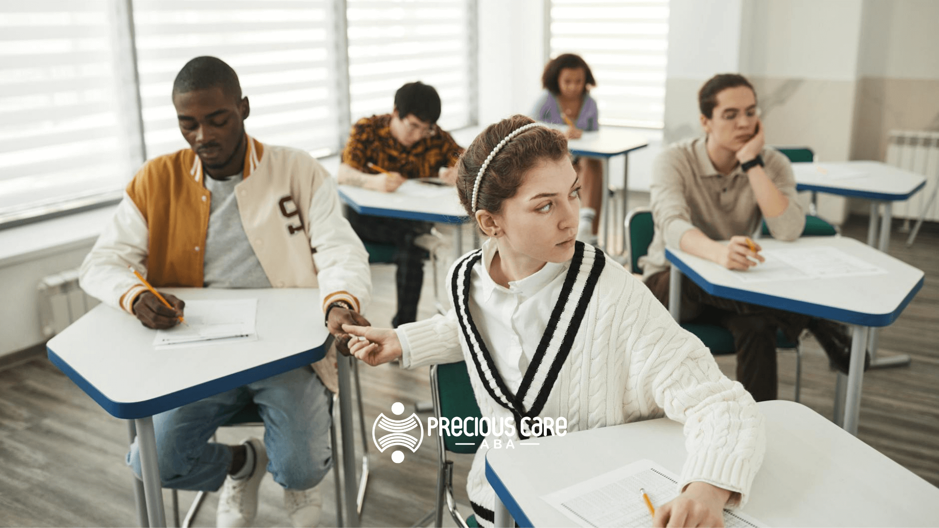 Students taking a test for ABA exam, one student glances sideways at a classmate’s paper during exam