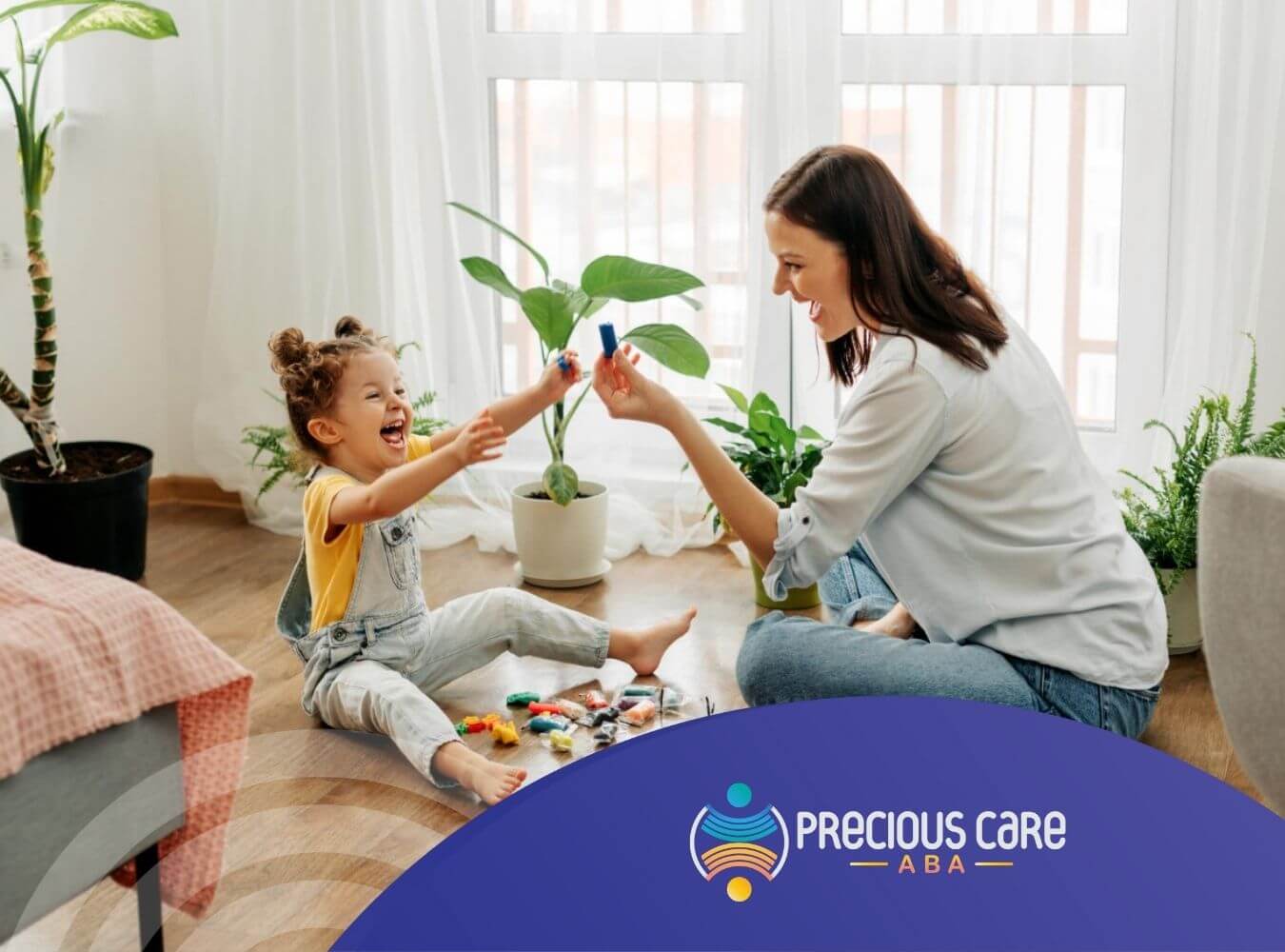 Female BCBA playing happily with child on floor during ABA therapy session.